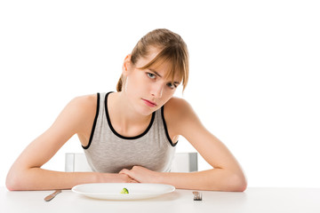 depressed slim woman with piece of broccoli on plate isolated on white