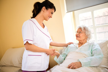 Obraz premium Senior woman patient with nurse at nursing home