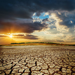 drought earth in sunset. dramatic sky over desert. change climat