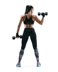 Strong woman working out with dumbbells, flexing her arm. Photo of sporty woman in sportswear on...