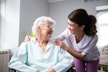 Fototapeta na wymiar Satisfied and happy senior woman patient with nurse