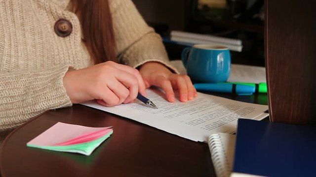 Business woman write, check and sign documents in office at workplace