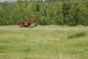 Fototapeta premium excavator working on a meadow.