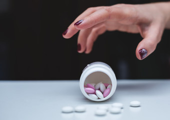 Depression and problem. Hand surrounded by many pills.