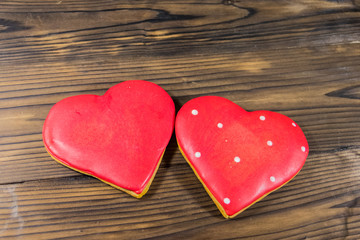 Fototapeta na wymiar Heart shaped cookies for valentine day on wooden table. Top view