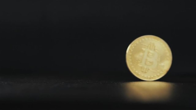 Gold bitcoin coin stacked against a dark background close-up. Bitcoin cryptocurrency in hand ethereum ico blockchain
