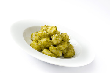 Gnocchi with pesto sauce in plate isolated on white background

