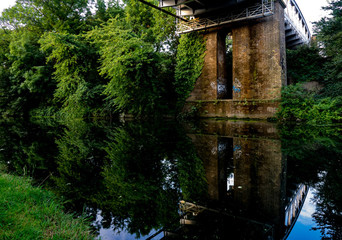 Canal in London with tube bridge structure reflected in water