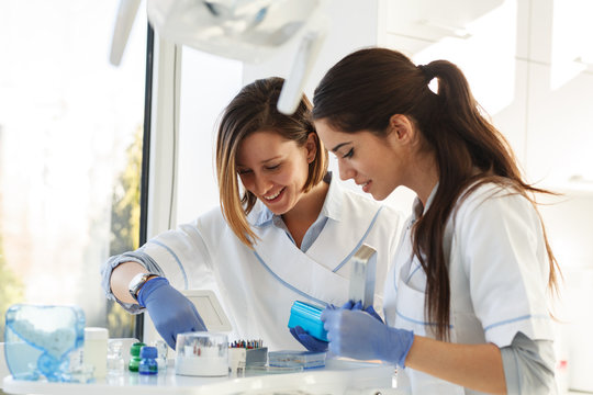 Female dentists in dental office .They cleans  equipment for next working day.