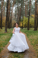 Fototapeta na wymiar happy bride on autumn forest. young beauty bride with big eye