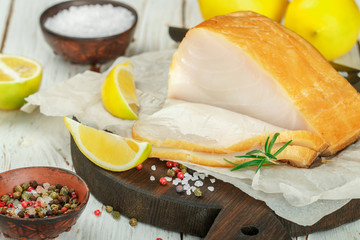 Salted white fish with lemon, rosemary and spices salt and pepper.  Butterfish. Halibut