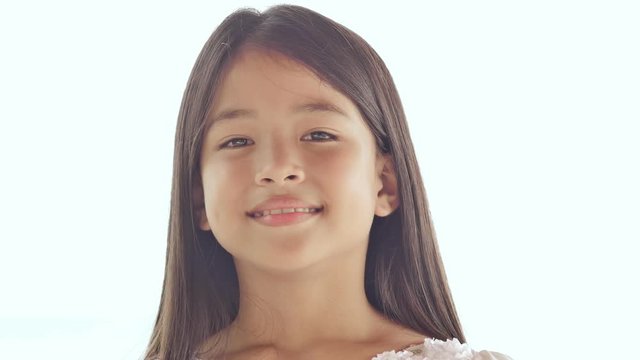 Charming philippine schoolgirl posing. Face close-up on white background nature. Summer.