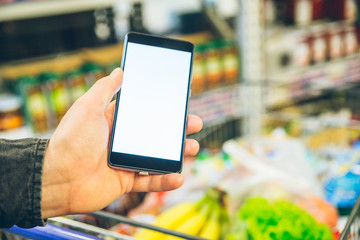 man look into phone for a shopping list