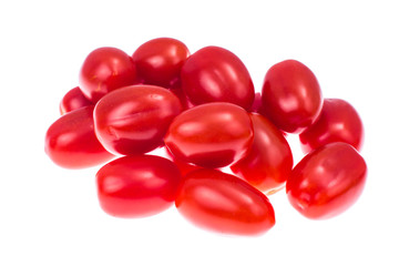 Small red tomatoes on light background