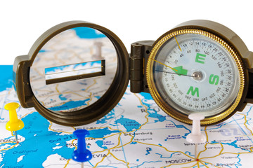 Magnetic compass on a world map conceptual of global travel , tourism and exploration.