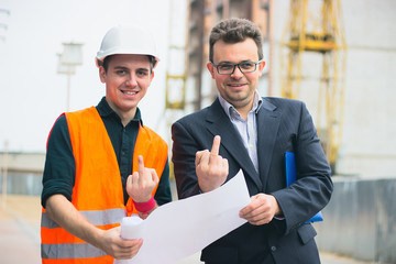 Young business man at construction business plans to make their work more efficient.. Warm orange...