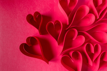 Obraz na płótnie Canvas handmade Valentine paper craft red hearts in a group top view