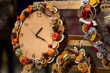 Decorative clock with dried aromatic fruits and vegetables.