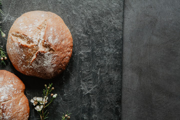 Irish soda bread in a rustic setting on an old black stone with little white flowers