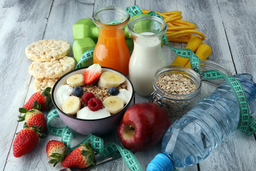 muesli with dairy and fruit, healthy lifestyle. bowl of cereal, fruit and dumbbell