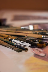 Brushes stained with paints lying on the table