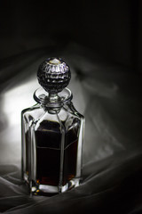 Transparent crystal carafe with dark liquid inside
