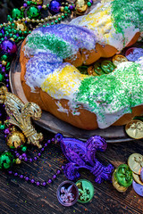 king cake surrounded by mardi gras decorations