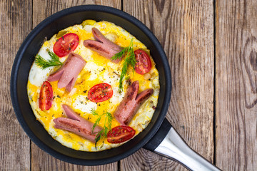 Breakfast for the family. Omelette with sausages