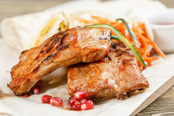 Grilled pork ribs. Serving on a wooden Board on a rustic table. Barbecue restaurant menu, a series of photos of different meats