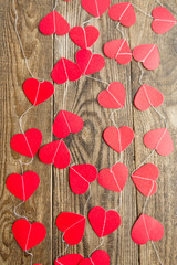 a lot of red hearts on a brown wooden background