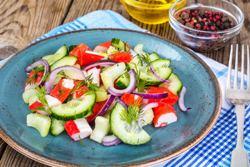 Spicy surimi salad on blue plate
