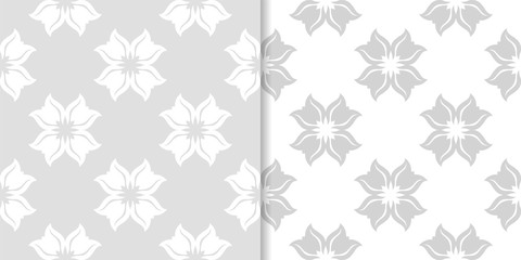 Light gray floral backgrounds. Set of seamless patterns