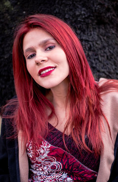Girl with red hair dark background