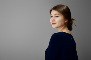 Beautiful girl with no make up half turned in profile