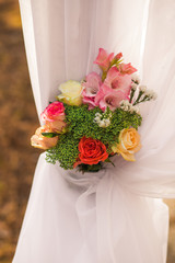 Floral elements of wedding decorations. Settings for romantic wedding ceremony outside at sunny forest. Vertical color photography. 