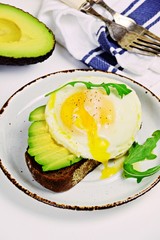 Poached Eggs And Avocado Toast on the white background. Healthy breakfast