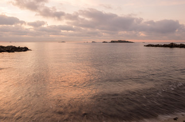 A violet sunrise on the beach of Ses figueretes, Ibiza