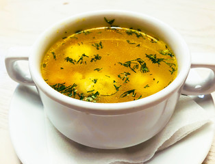 Chicken hot broth in white soup tureen