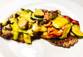 Steak with sauce with vegetables and mushrooms