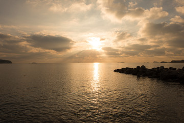 Fototapeta na wymiar A golden sunrise in the sea of Ibiza