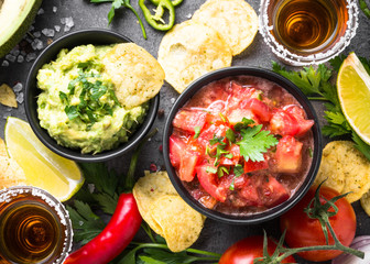 Latinamerican food party sauce guacamole, salsa, chips and tequi