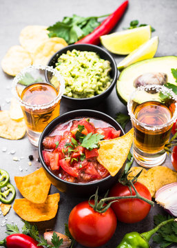 Latinamerican food party sauce guacamole, salsa, chips and tequi