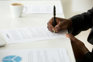 African american businessman agree to make deal signing business contract concept, black man hand...