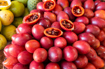 Table of Bright Red Tamarillos at the Market