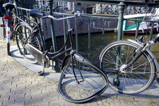 Broken Bicycle on the Side of a Canal in Amsterdam, Netherlands
