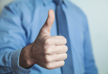 Businessman showing a thumbs up sign.