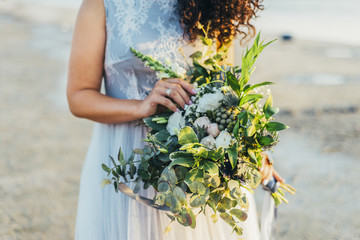 Bride holding wedding bouquet in her hands