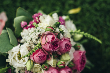  wedding bouquet with rings on the grass