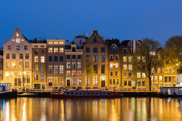 Fototapeta na wymiar Canals and tradition house in Amsterdam at night. Amsterdam is the capital and most populous city of the Netherlands.
