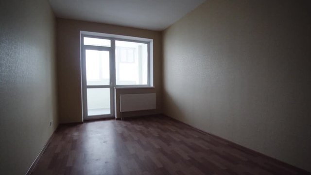 Empty bright living room without furniture. Clip. Interior empty light room without furniture in a new building renovation or under construction
